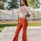 Side view of Eastcoast Flare Cord pants in a rust color and flared leg. 