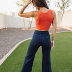 Rear view of Sailor Jean in dark indigo color with wide leg and rear pockets. 