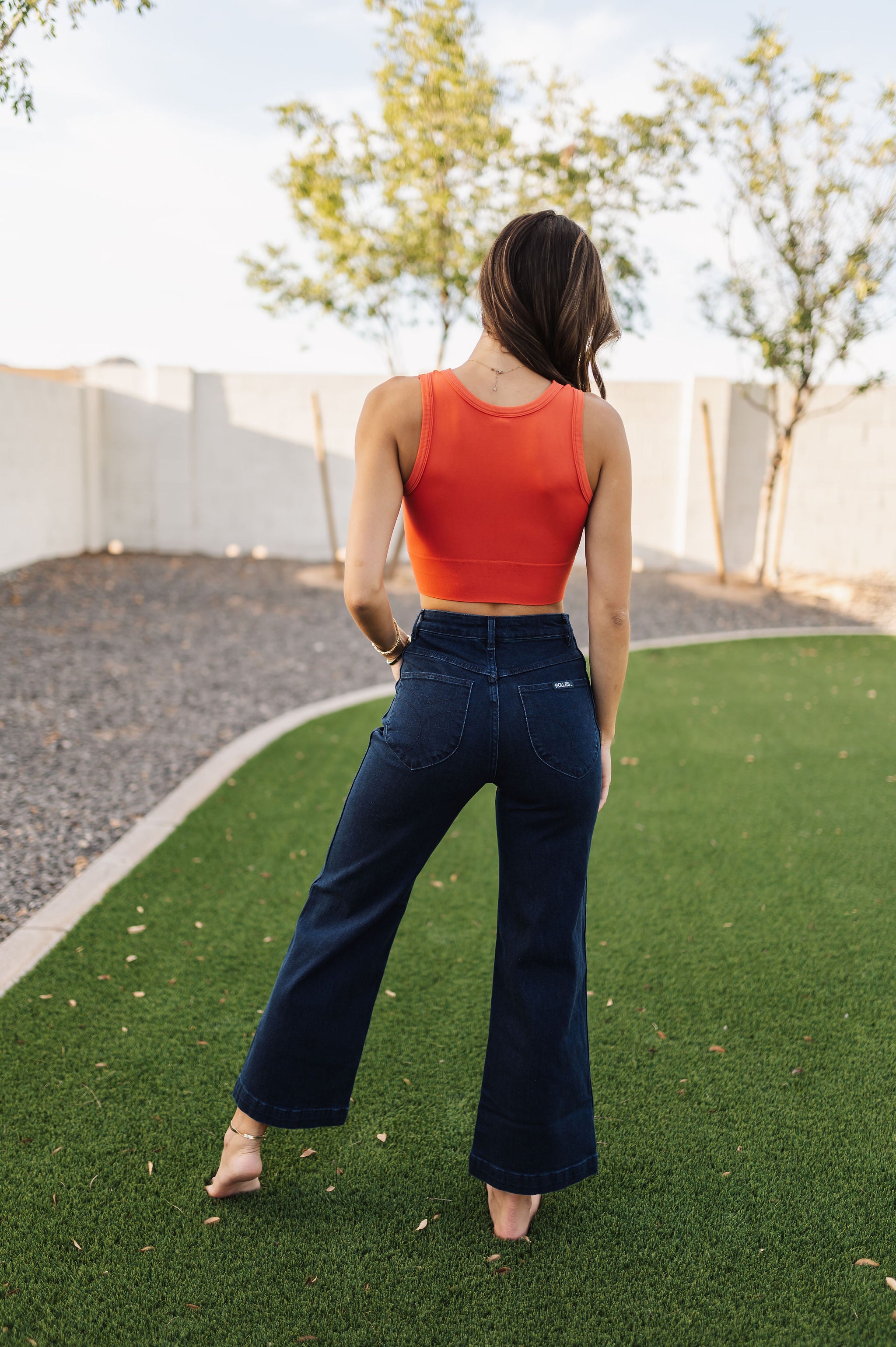 Rear view of Sailor Jean in dark indigo color with wide leg and rear pockets. 