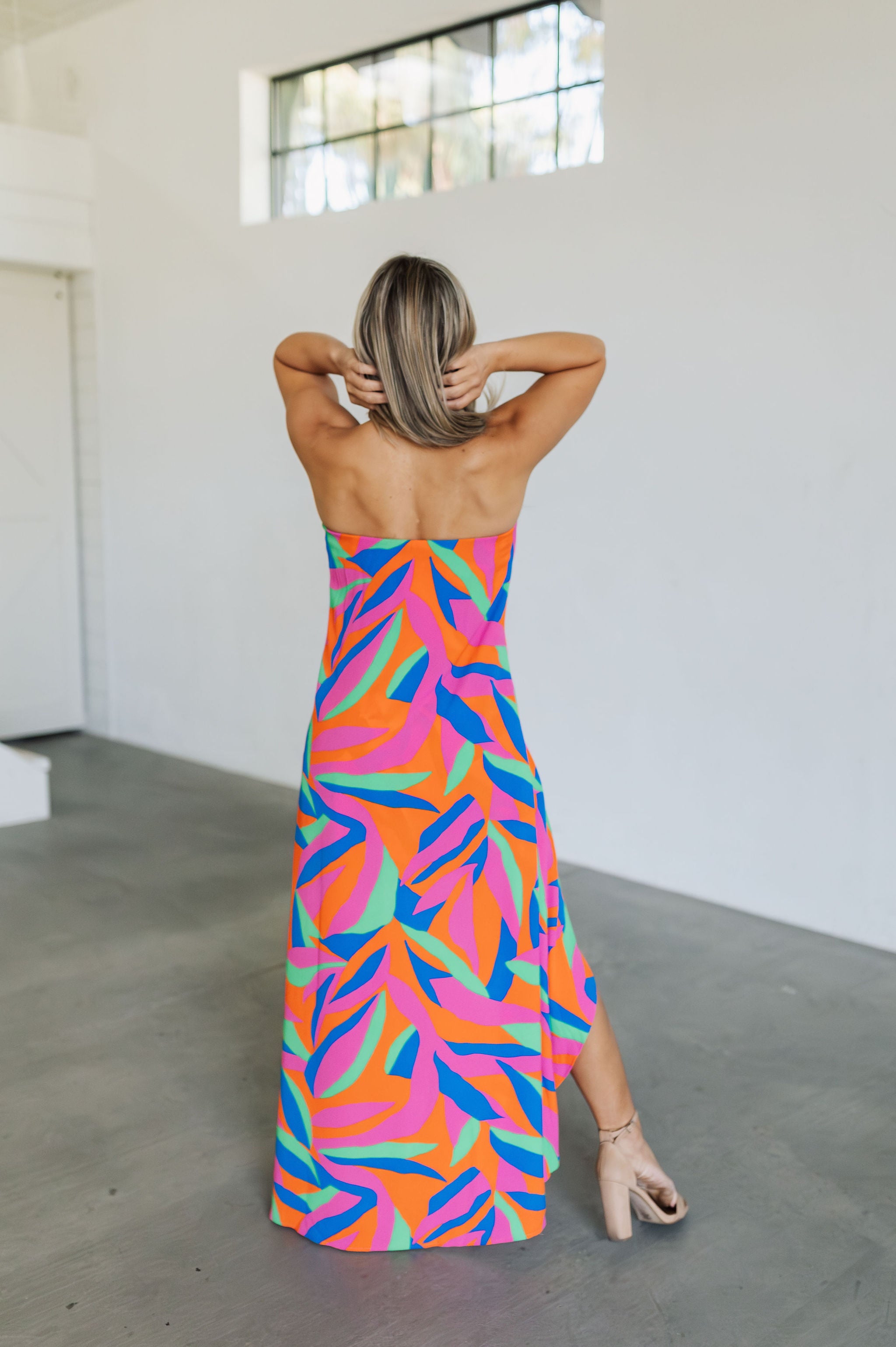 Rear view of high-low maxi Ipanema Tie Dess with vibrant allover print.