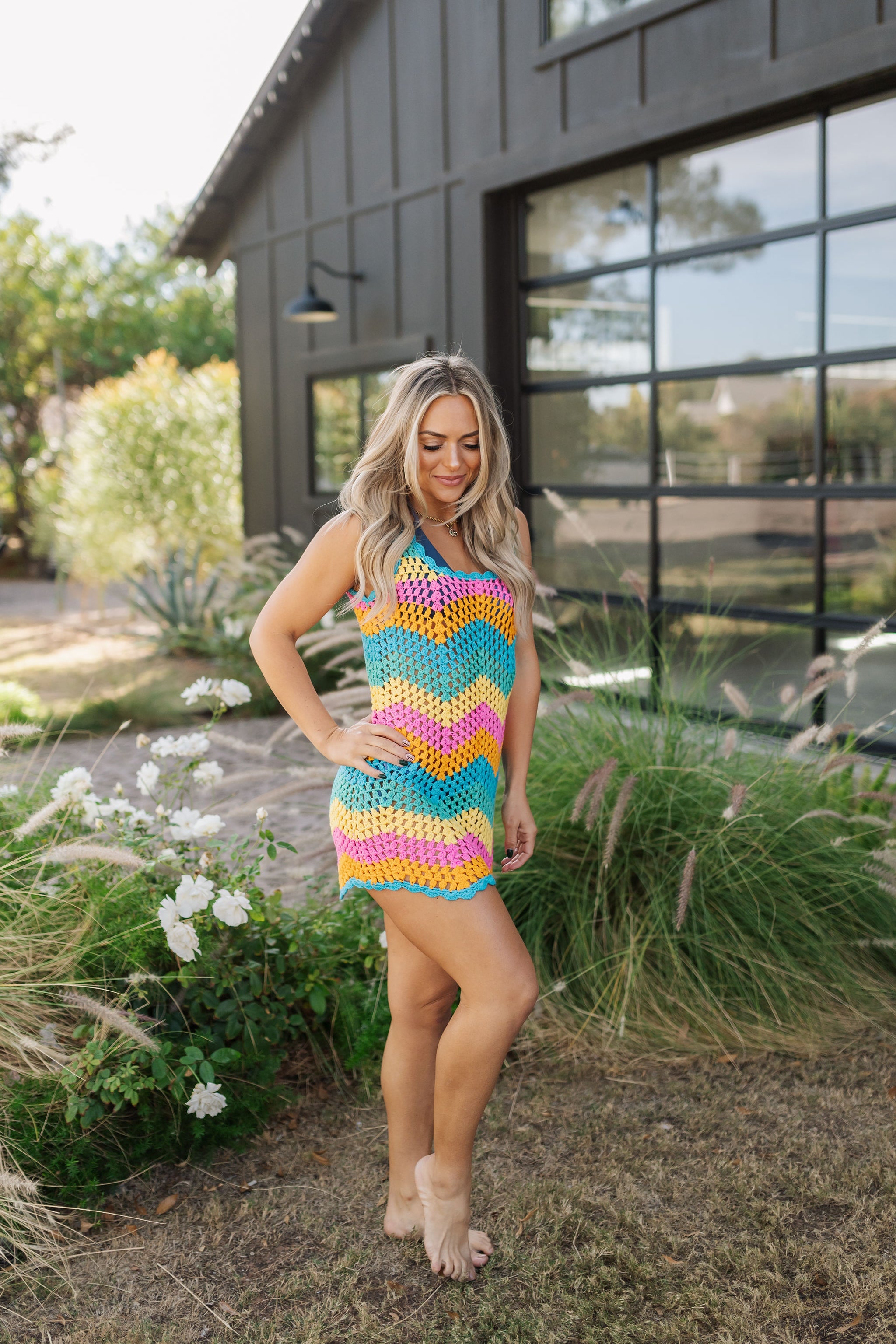 Front angled view of crochet Tara Mini Dress with neon zig zag print.