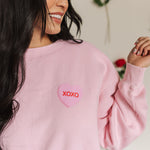 Close up front view of The Stanley Sweatshirt crewneck with heart graphic detail.