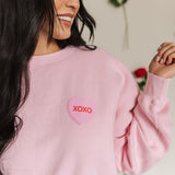 Close up front view of The Stanley Sweatshirt crewneck with heart graphic detail.