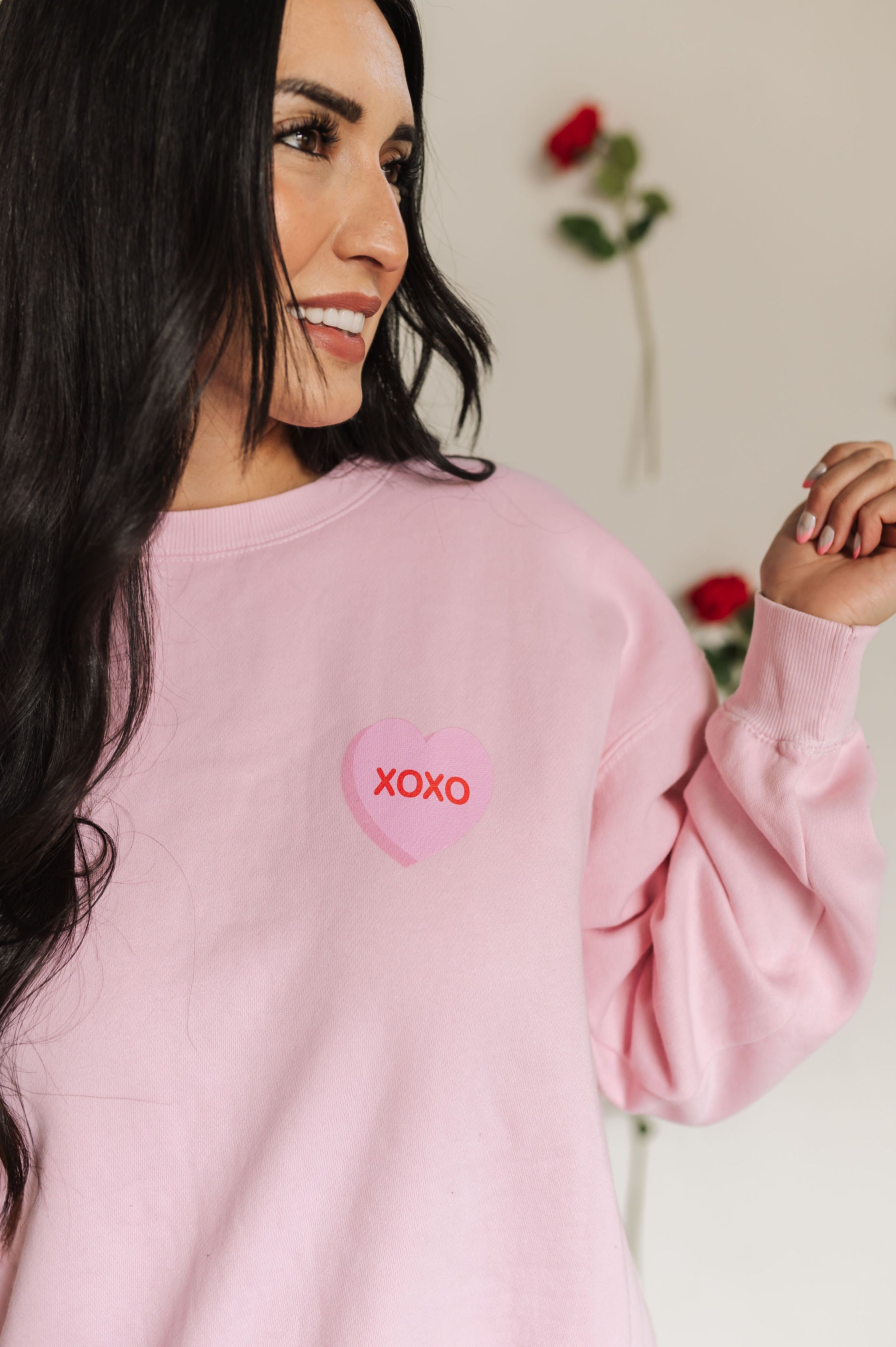 Close up front view of The Stanley Sweatshirt crewneck with heart graphic detail.