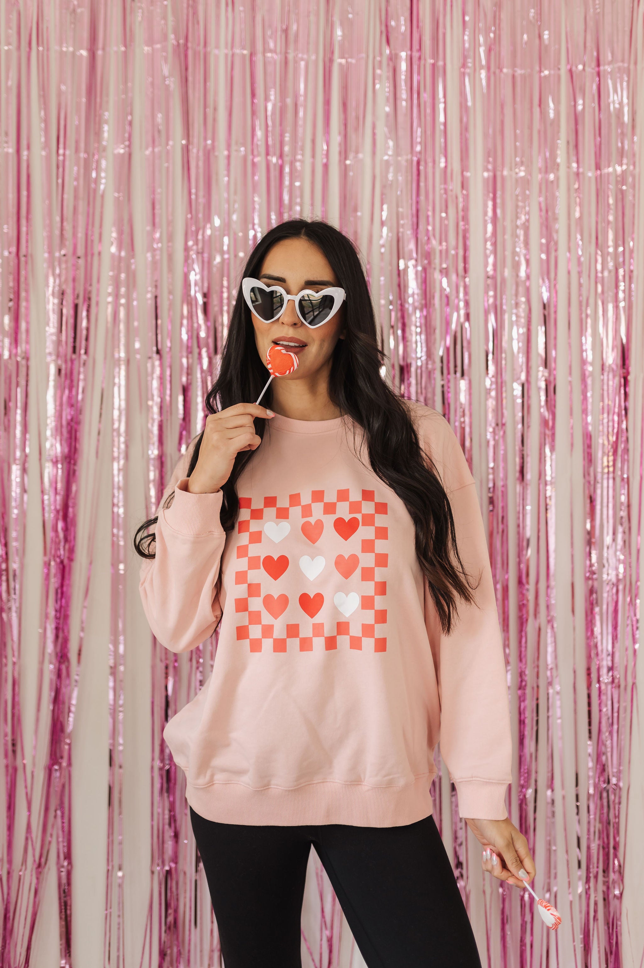 Front view of Candy Hearts Sweatshirt with heart and checkered design. 