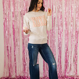 Front view of crewneck XOXO Glitter Graphic Sweatshirt with glitter details. 