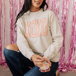Front view of crewneck XOXO Glitter Graphic Sweatshirt with glitter details.