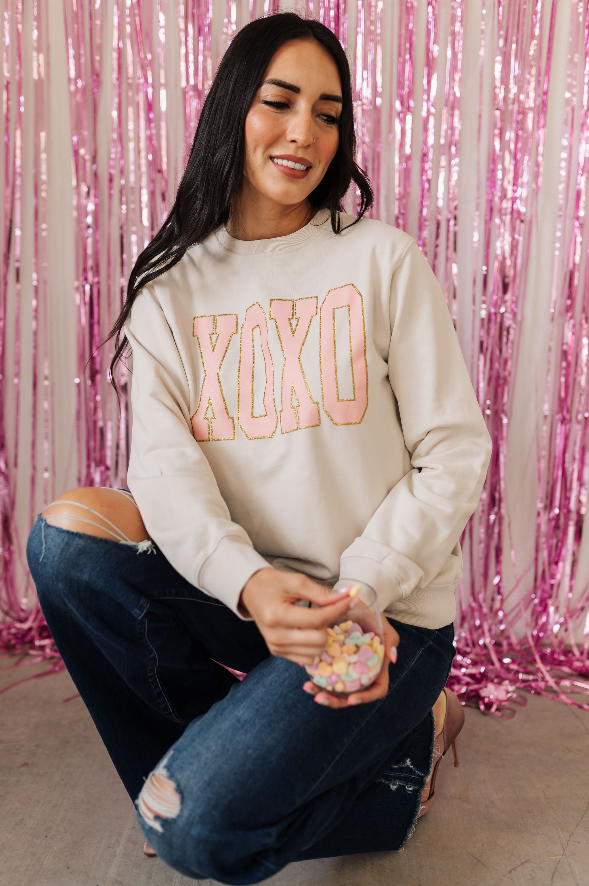 Front view of crewneck XOXO Glitter Graphic Sweatshirt with glitter details.