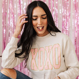 Front view of crewneck XOXO Glitter Graphic Sweatshirt with glitter details.