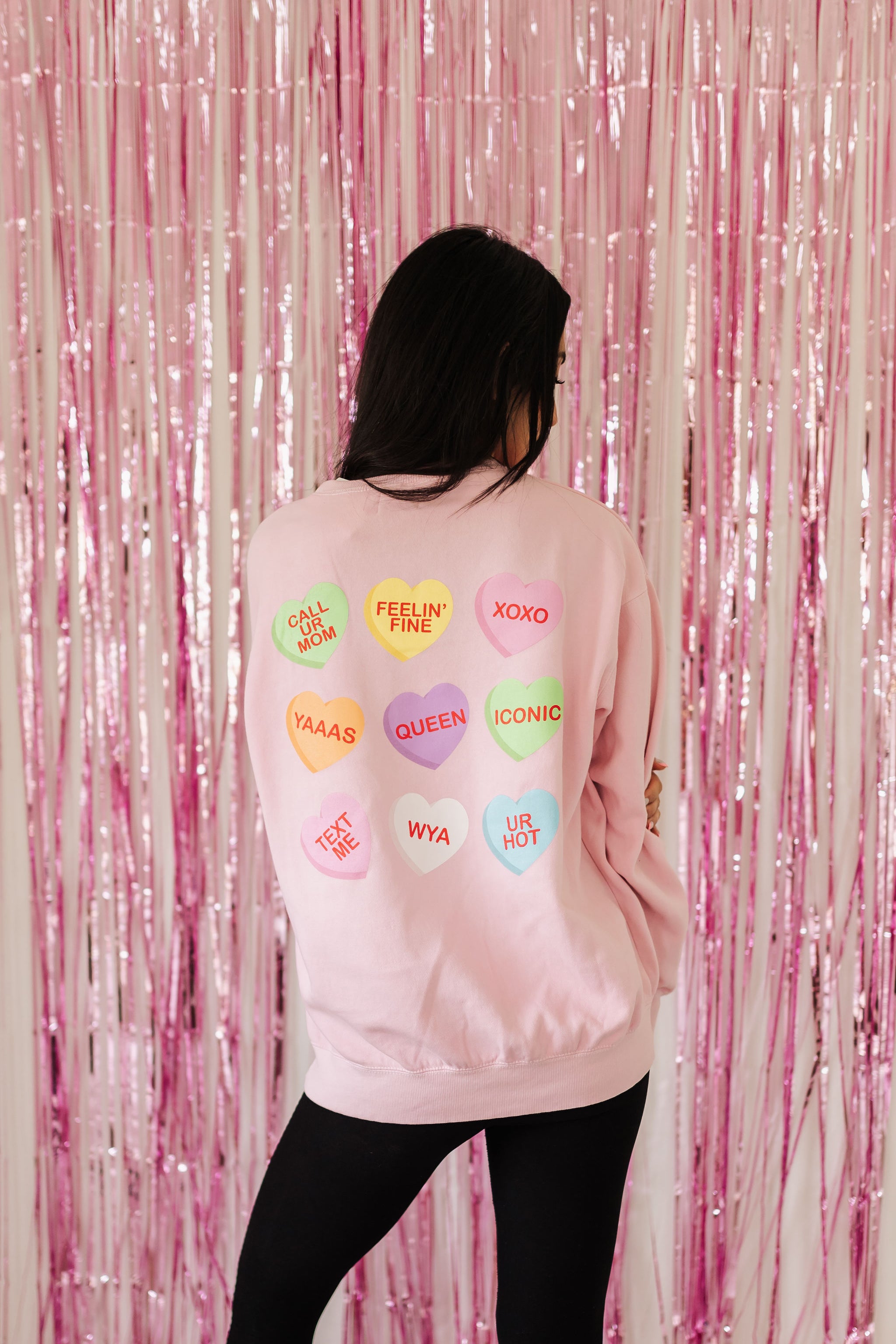 Rear view of The Stanley Sweatshirt crewneck with allover candy heart design. 