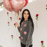 Front angled view of Glitter Hearts Sweatshirt in aged gray with crewneck and glitter details. 