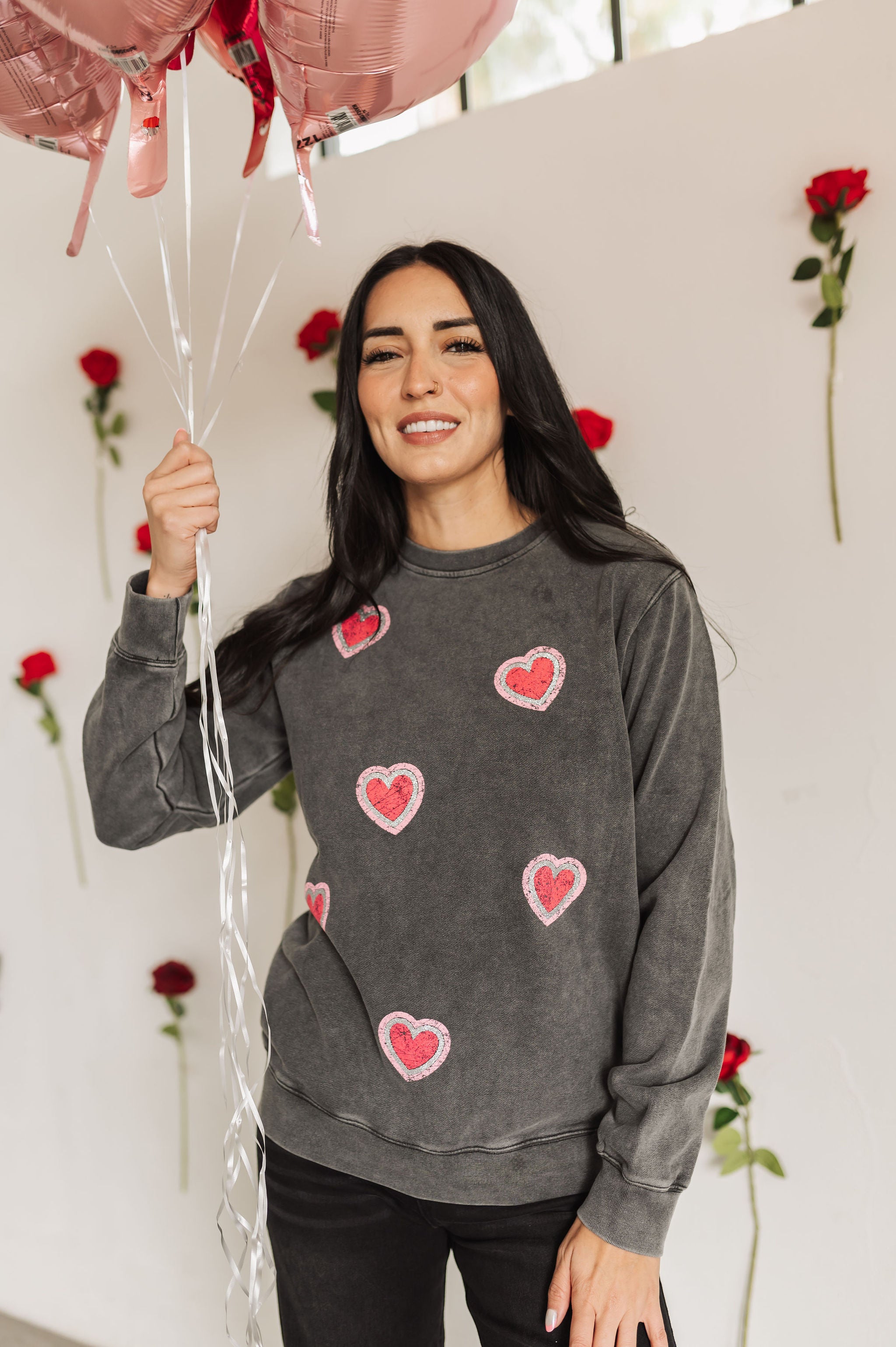 Front view of Glitter Hearts Sweatshirt in aged gray with crewneck and glitter details. 