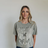 Front view of World Tour Graphic Tee with mineral wash, distressed graphic, and raw hem. 