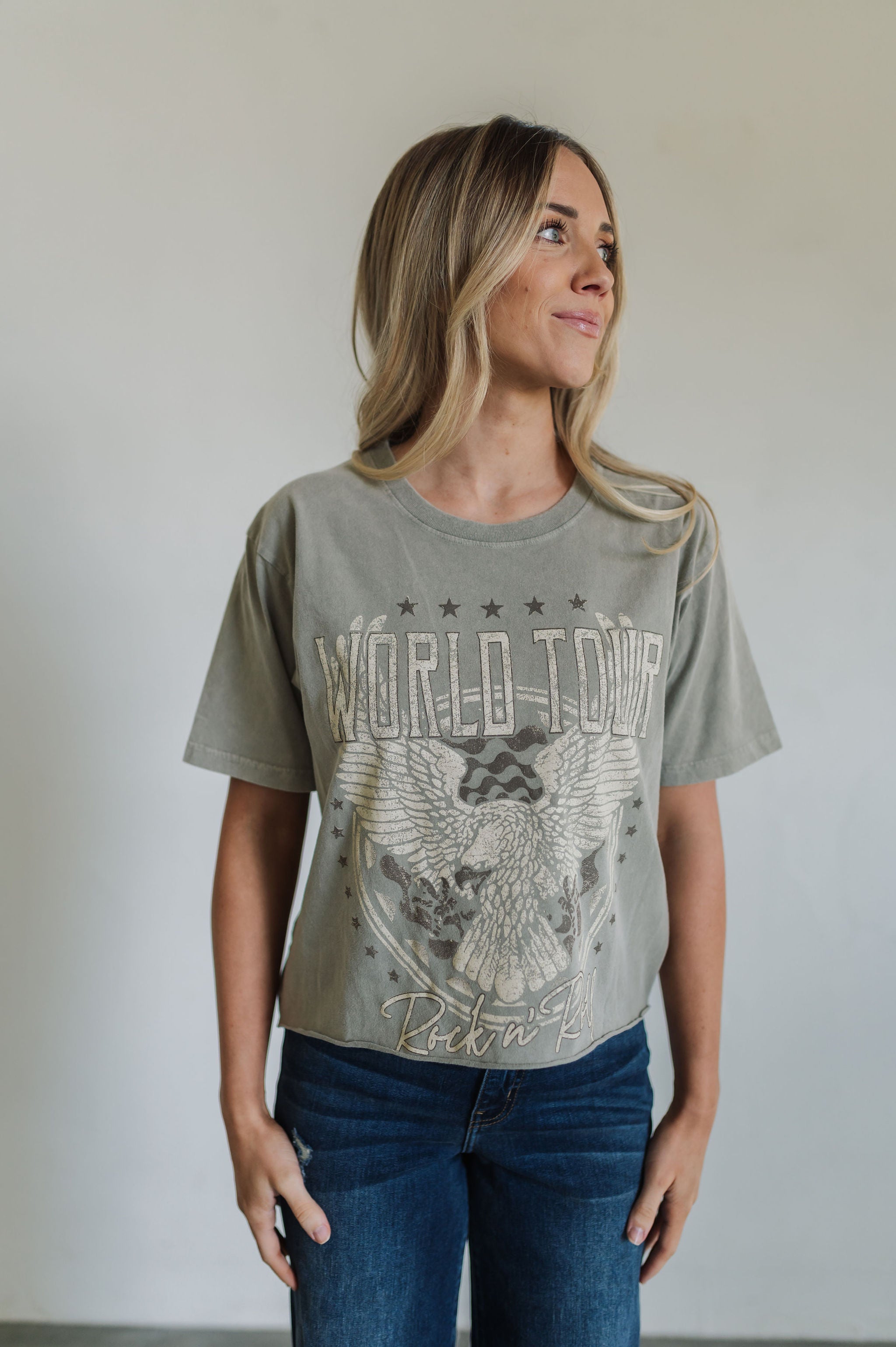 Front view of World Tour Graphic Tee with mineral wash, distressed graphic, and raw hem. 