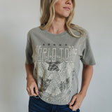 Front view of World Tour Graphic Tee with mineral wash, distressed graphic, and raw hem. 