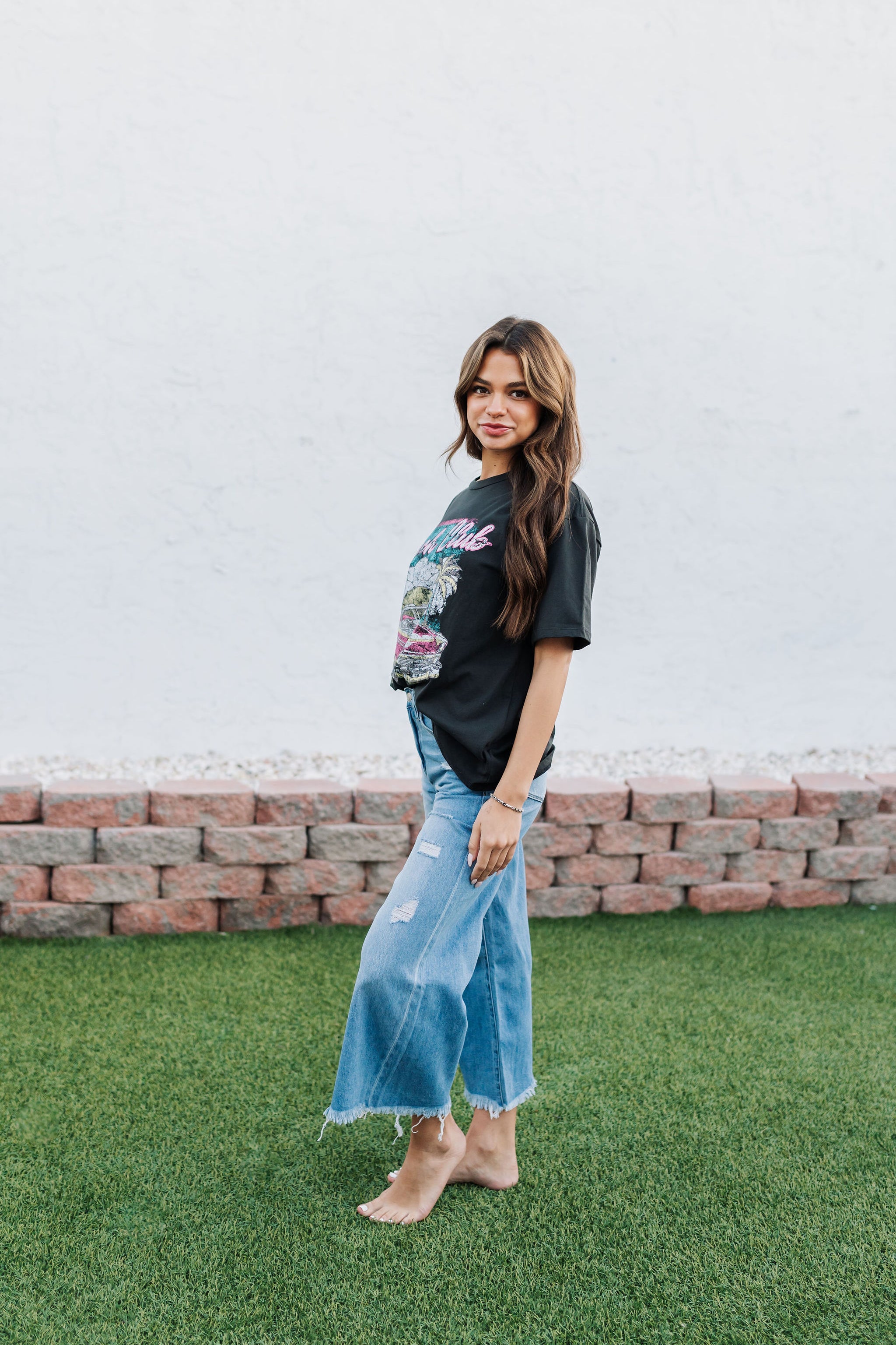 Side view of Beach Club Vintage Graphic Tee with distressed graphic.