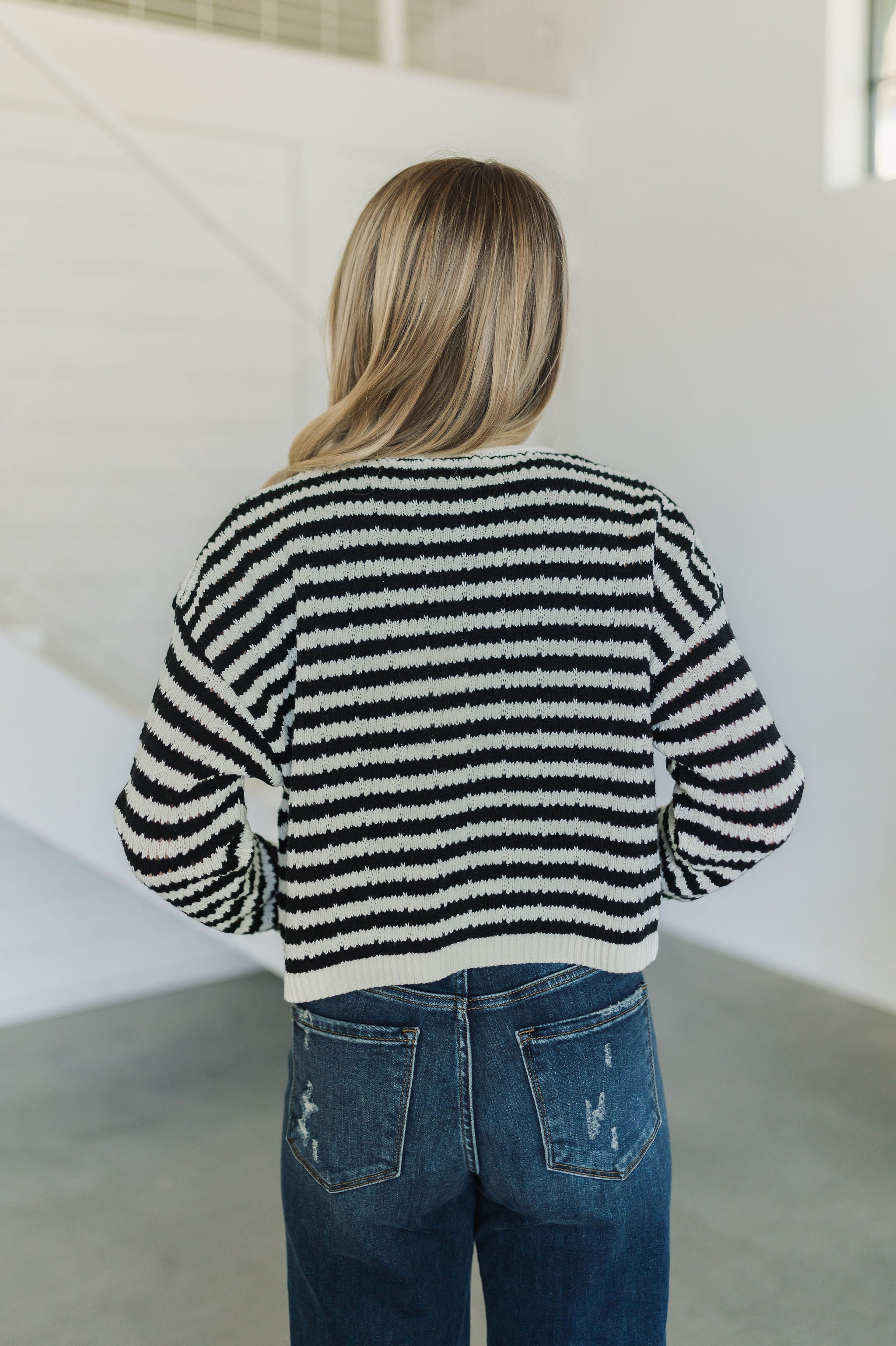 Rear view of  Beverly Crochet Knitted Cardigan with black and white stripes. 