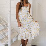 Front view of Summer Fling Midi Dress with embroidered Limoncello print, thin straps, square neckline, and ruffled hem. 