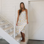 Front view of Summer Fling Midi Dress with embroidered Limoncello print, thin straps, square neckline, and ruffled hem. 