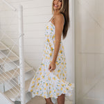 Side view of Summer Fling Midi Dress with embroidered Limoncello print, thin straps, and ruffled hem. 