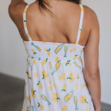 Rear view of Summer Fling Midi Dress with embroidered Limoncello print, thin straps, and smocked back.