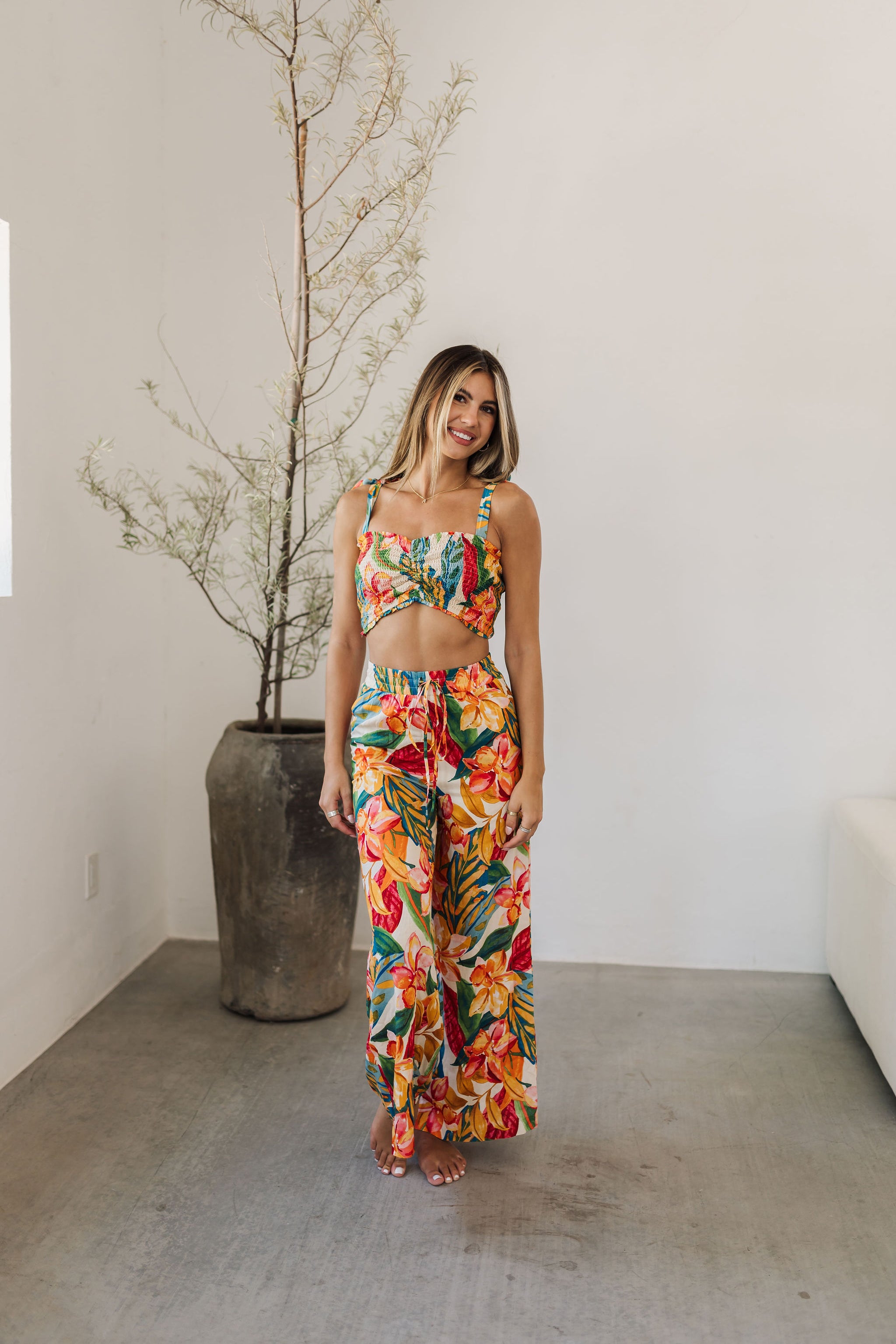 Front view of St. Tropez Wide Leg Pants with elastic tie waist and allover tropical print. 