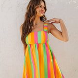 Close up front view of neon striped Fling Mini Dress with smocked straps. 
