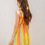 Rear angled view of neon striped Fling Mini Dress with smocked straps and back.