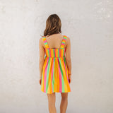 Rear view of neon striped Fling Mini Dress with smocked straps and back.