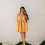 Front view of neon striped Fling Mini Dress with smocked straps. 