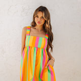 Front view of neon striped Fling Mini Dress with smocked straps and side pockets.