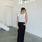 Front view of Chloe Pleat Linen Pant in black with relaxed leg and side pocket. 