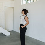 Side view of Chloe Pleat Linen Pant in black with relaxed leg and side pocket. 