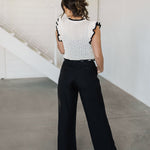 Rear view of Chloe Pleat Linen Pant in black with relaxed leg and trouser pockets. 