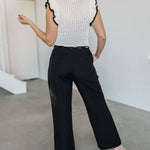Rear view of Chloe Pleat Linen Pant in black with relaxed leg and trouser pockets.