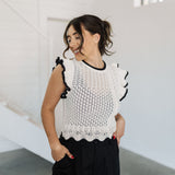 Front view of pointelle knit Piper Knit Top with ruffled sleeves and hem and contrast piping detail. 