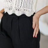 Up close view of Chloe Pleat Linen Pant in black with pleat front detail and side pocket.  