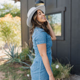 Side view of  Ranch Romper in blue with zippered front and patch pocket on the chest and hip, and rear embroidered pocket.