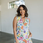 Front view of sleeveless Reno Romper in allover floral print, zip up front, collared neckline, and side pockets.