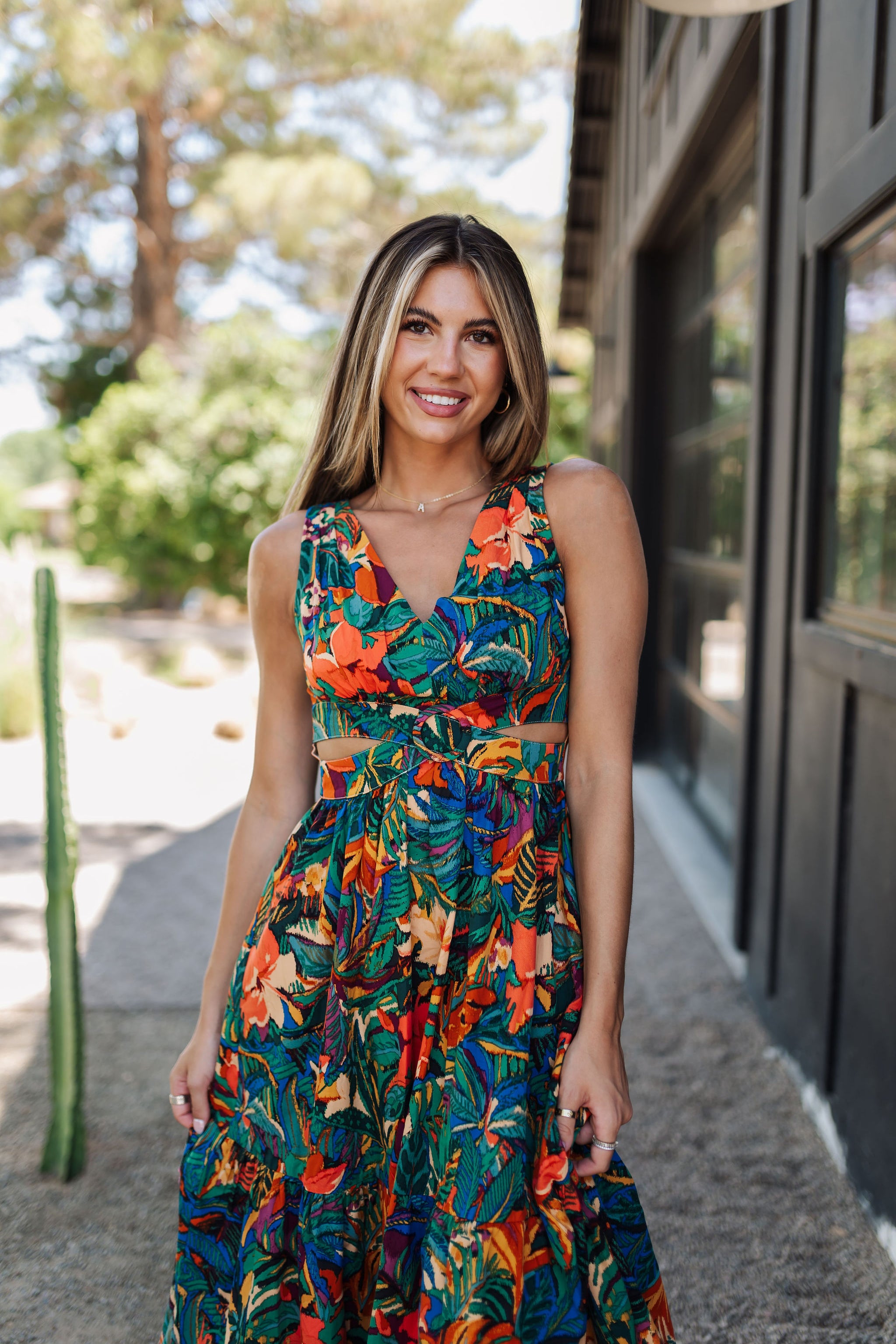 Front view of Tropical Isle Cut Out Midi Dress with allover floral print, V-neck, wide shoulder straps, and side cutouts. 