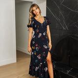 Front view of Dahlia Floral Maxi Dress with V-neckline, puff sleeves, ruffled hem and side slit. 