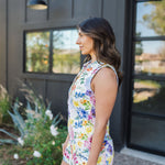 Side view of sleeveless Reno Romper in allover floral print, zip up front, and collared neckline. 
