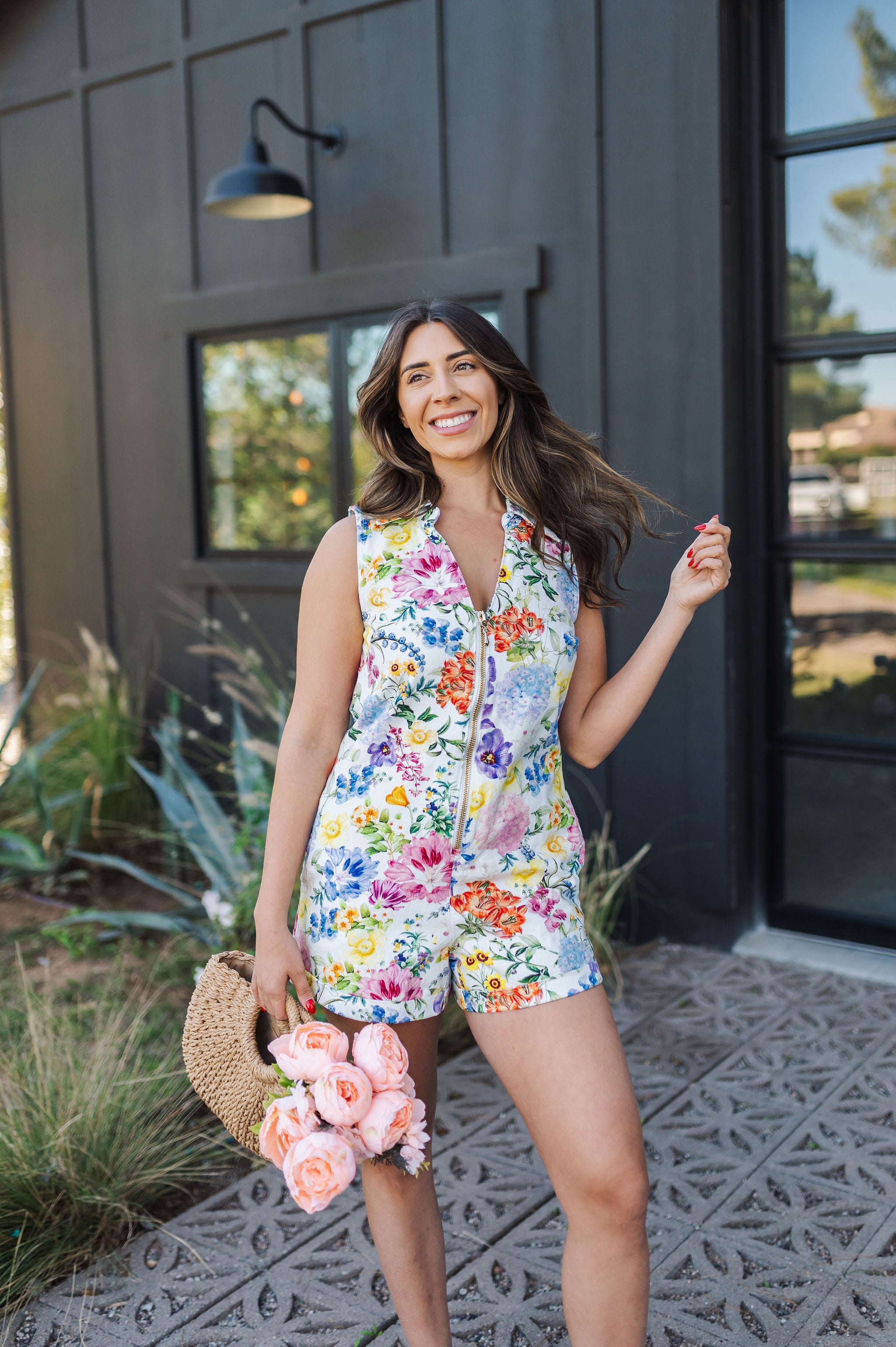 Front view of sleeveless Reno Romper in allover floral print, zip up front, and collared neckline. 