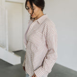Side view of Kennedy Striped Button Down Long Sleeve Shirt with fringe hemline and front chest pocket. 
