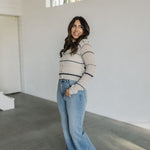 Side view of striped button up Hazel Cardigan with scoop neck.