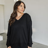 Front view of black Auden V-Neck Long Sleeve Top with waffle-knit design.