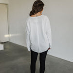 Rear view of Harper Long Sleeve Top with raw hem. 