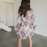 Rear view of Aster Floral Mini Dress with long sleeves and ruffled hem. 