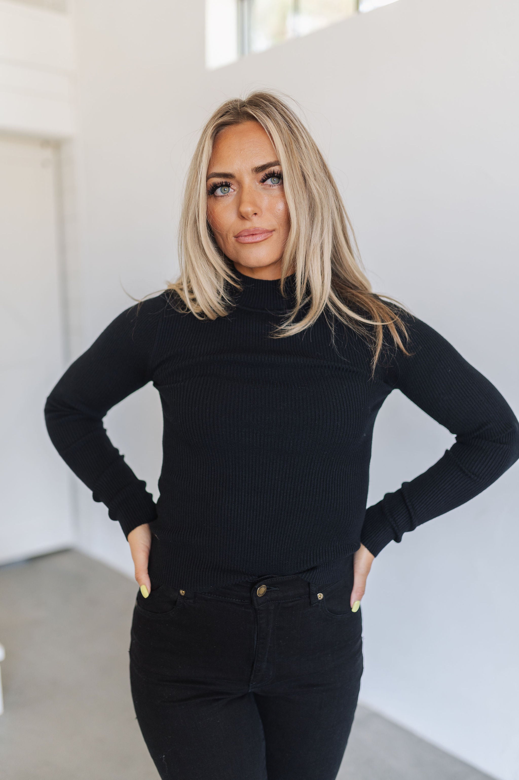 Front view of cropped black  Mock Turtle Neck.