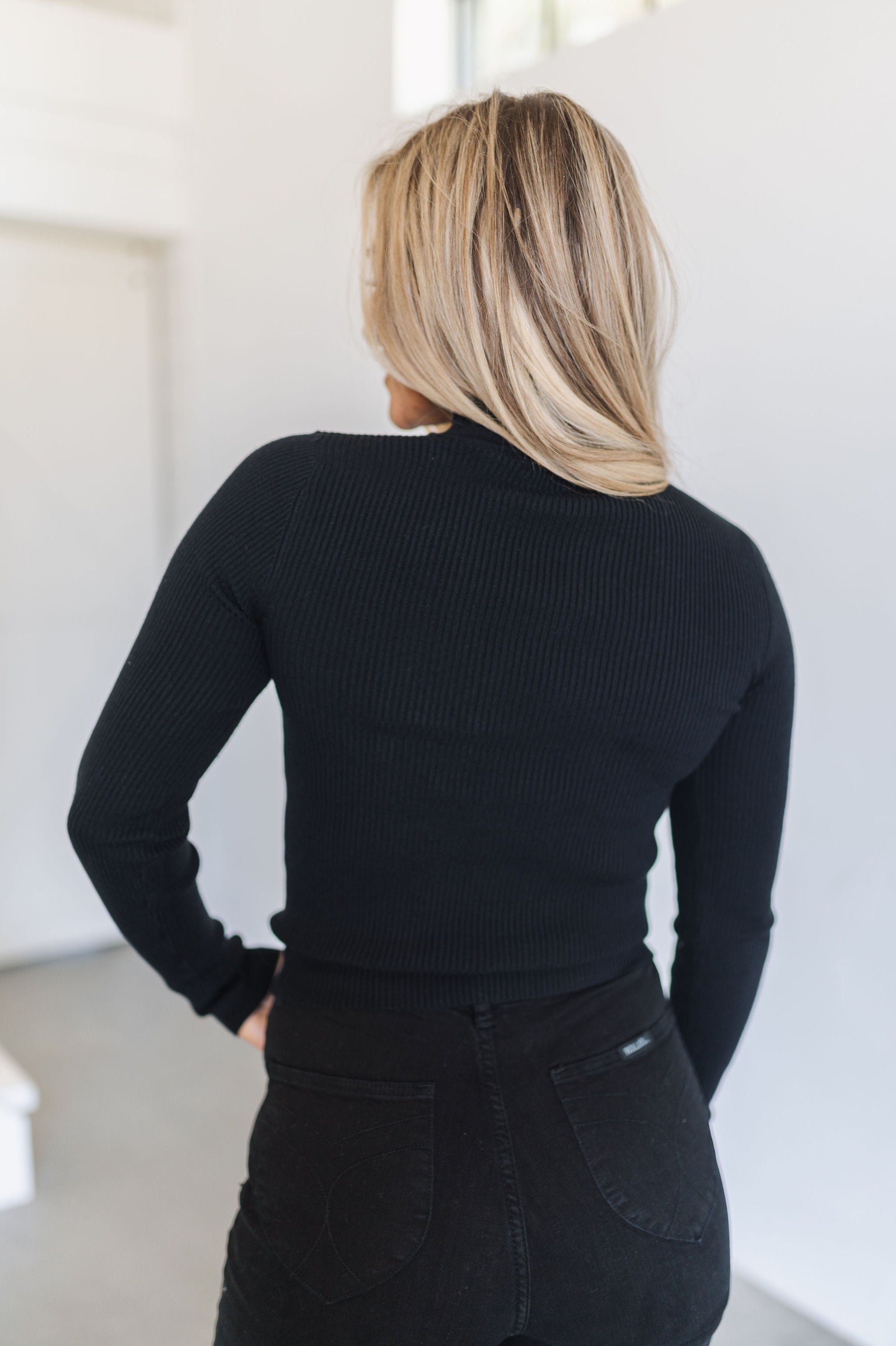 Rear view of cropped black  Mock Turtle Neck.